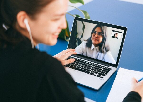 Two women communicating online via video chat